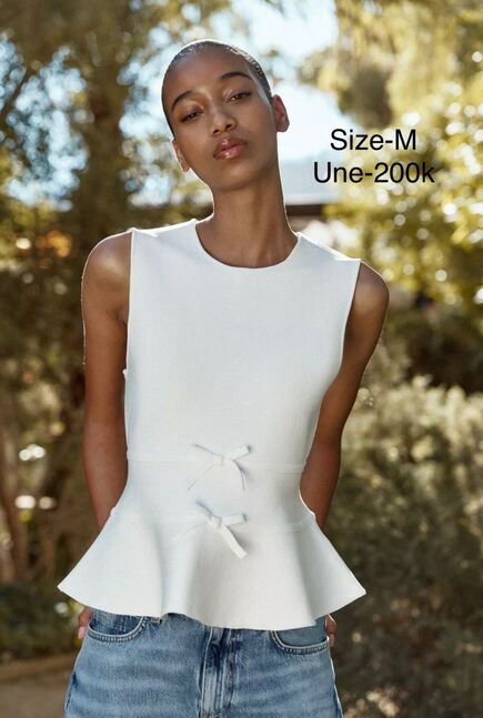Knit peplum top with ties